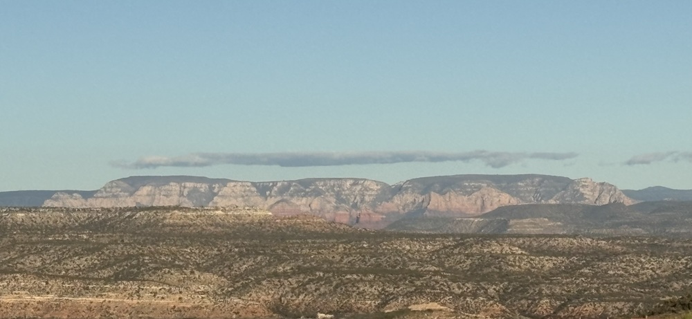 Craig Spiesman photo featuring distant rocky plateaus across an open desert landscape